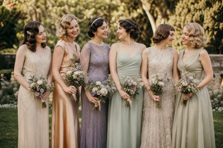 Vintage bridesmaid dresses in sage chiffon with soft 1950s-inspired silhouettes at a golden-hour garden wedding