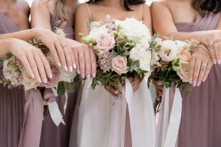 Wedding nails for bridesmaids in soft blush pink with a glossy finish on almond-shaped nails, photographed close-up